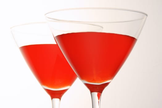 Close-up of two cocktail glasses with red liquid inside