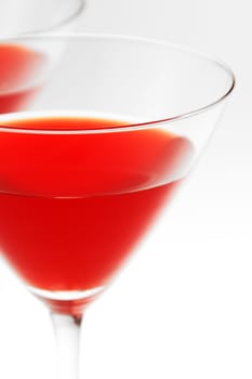 Close-up of two cocktail glasses with red liquid inside