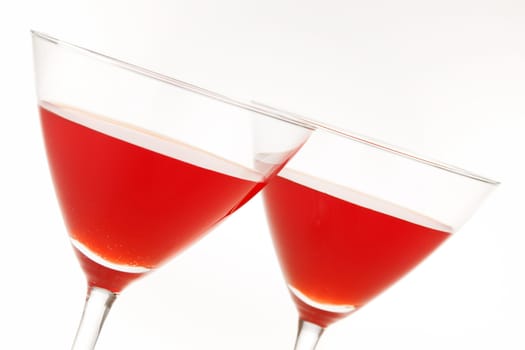 Close-up of two cocktail glasses with red liquid inside