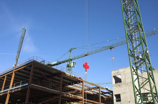 Large scale construction site with construction cranes.
