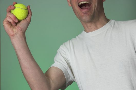 Man yells as he catches a tennis ball.
