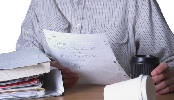 Maths student revising for exam, fuelled by take away coffee. Shallow depth of field with the focus on the mathematical formulae on the paper.