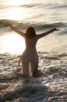 The girl in wet dress on seacoast