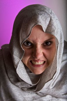 An angry young girl in a white shawl