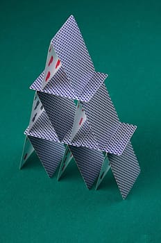 A house of cards on green felt