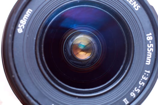 A photographic lens seen from the front, over white