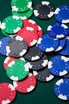 Poker chips on green felt