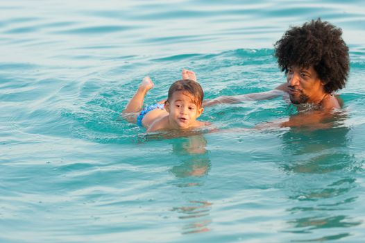 First time swimming lesson with proud daddy