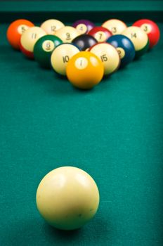 A cue ball is ready to start a game of billiards, focus is on the cue ball