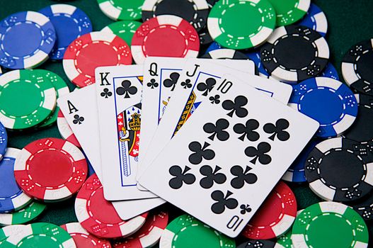 A "royal flush" poker hand is fanned out on top of poker chips