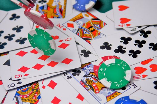 poker chips tumble on to a pile of cards