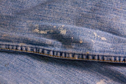 Faded and stained denim material
