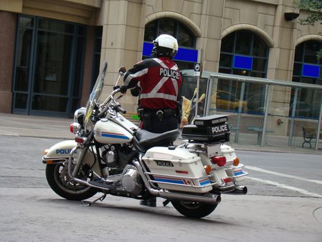 Motorcycle policeman directing traffic during a labor march