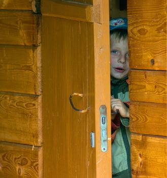 The boy looking out from for doors.