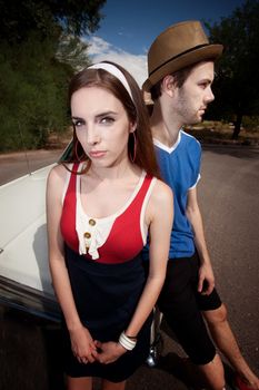 Hipster Couple Leaning on an Old Car