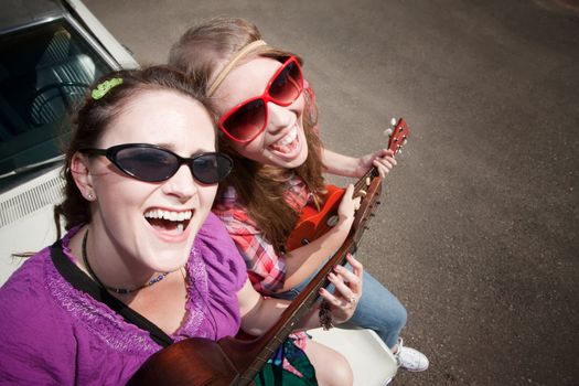 Female Musicians on an Old Car