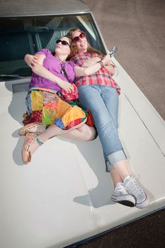 Sleeping women on an old car hood