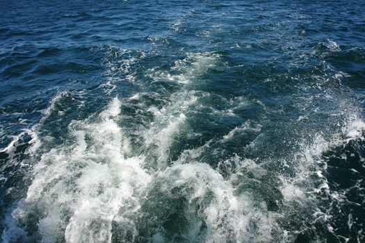 Large boat water wake trail left over the sea ocean - great boating sailing background