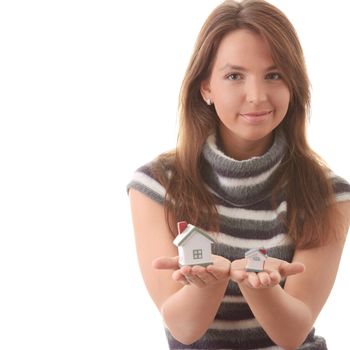 Young woman with two hose models in hands (compering them) isolated on white background - Real Estate loans concept