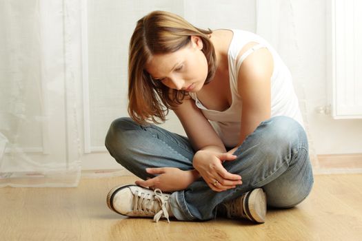 Young female sitting on the flor, stressed out, depressed and tired