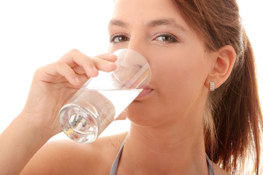 Young woman drinking fresh cold water from glass - isolated on white