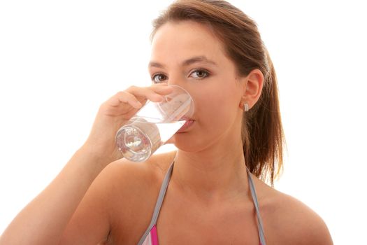 Young woman drinking fresh cold water from glass - isolated on white