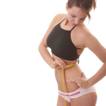 Young woman measuring waist