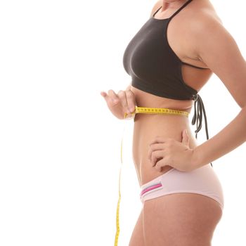 Young woman measuring waist