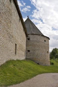 Old fortress tower and wall with portholes