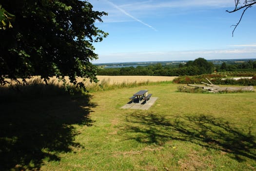 Picnic table in beautiful summer nature with amazing landscape background