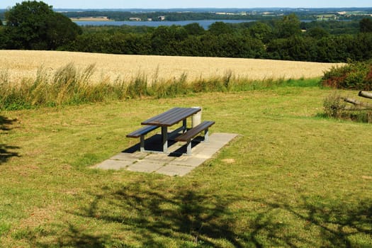 Picnic table in beautiful summer nature with amazing landscape background