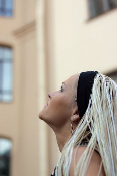 Young woman with braided near the building in the center