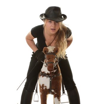 Young beautiful cowgirl (jockey) race on hobbyhorse with face expression isolated on white background (race concept).