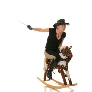 Young beautiful cowgirl (jockey) race on hobbyhorse with face expression isolated on white background (race concept).