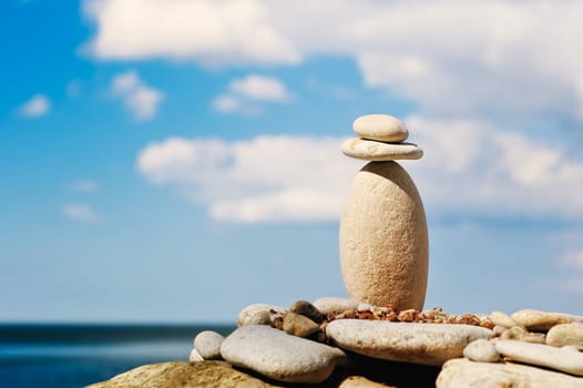 Two stones in balancing on top of a long gravel