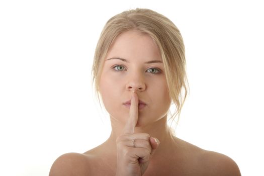 Closeup portrait of young woman covering her mouth with one finger - quiet