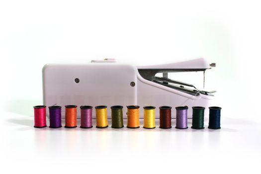 Overlocker and a set of coils with colour threads.