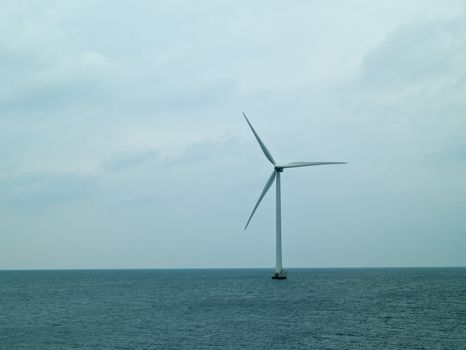 Alternative energy  huge wind mill in the sea generating electricity from nature