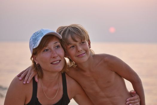 people series: mother an d his son on a sunset beach