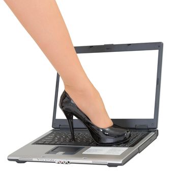 Female foot in a shoe on the laptop keyboard - game over