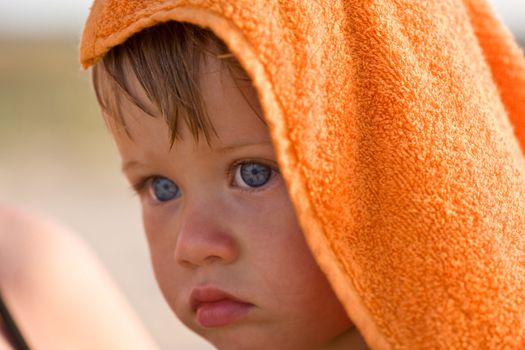 people series: portrait of little girl in orange towel