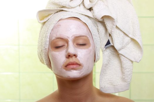 Portrait of a styled model with facial cream mask.