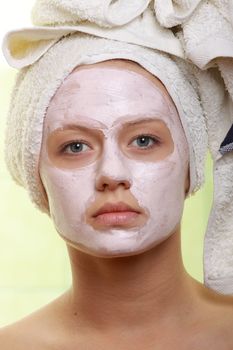 Portrait of a styled model with facial cream mask.