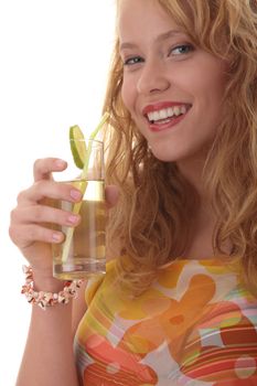 Young beautiful blond woman sipping cocktail (green ice tea) over white background