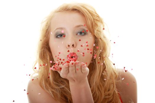 Pretty young woman blowing a kiss with a swirl of hearts on white background