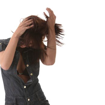 Sexy, beautiful, young woman dancing (hair flying) in jeans siut isolated on white background