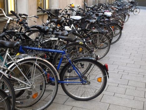 Row of bikes or bicycles parked - selective focus, copy space