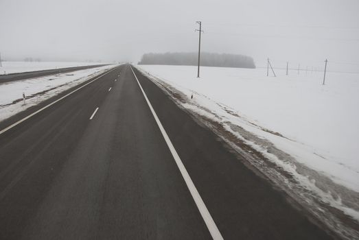 winter highway and morning mist