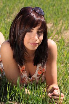Beautiful and sexy young woman relaxing in the grass