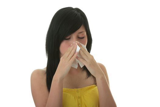 Young woman with allergy or cold holding handkerchief, isolated on white background